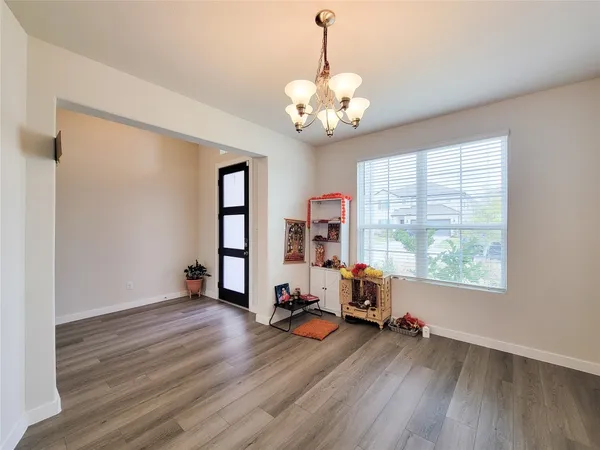 a view of a livingroom with wooden floor and a large window