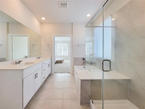 a large bathroom with a double vanity sink mirror and double