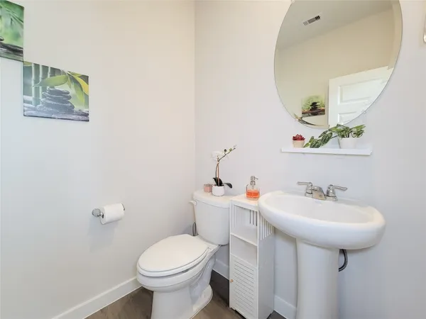 a bathroom with a sink toilet and a mirror