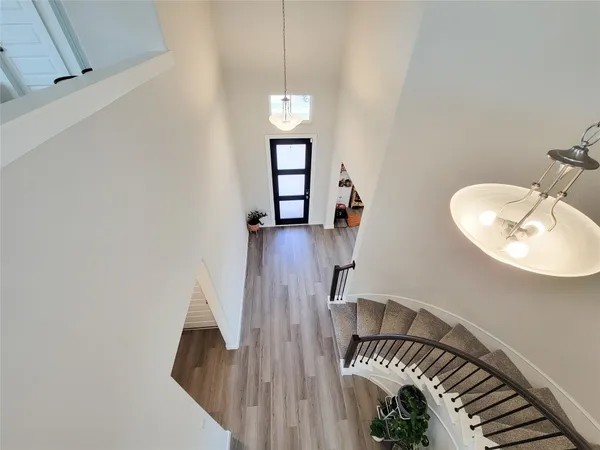 a view of a livingroom with furniture hardwood floor and front door