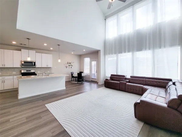 a living room with furniture and kitchen view