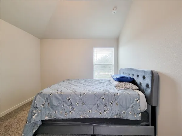 a bedroom with a bed and window