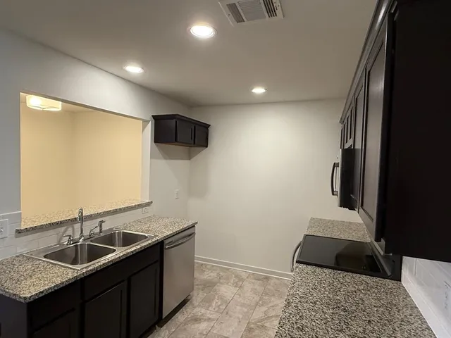 a kitchen with a sink and a refrigerator