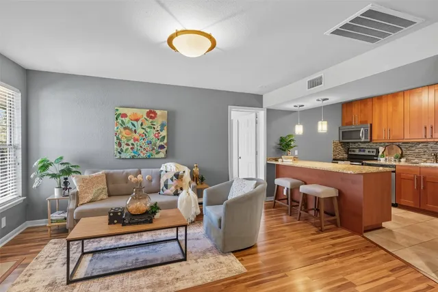 a living room with furniture a window and kitchen view
