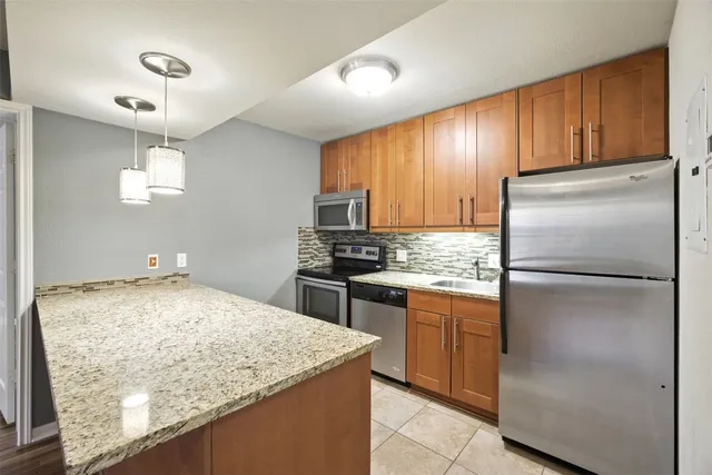 a kitchen with refrigerator and window