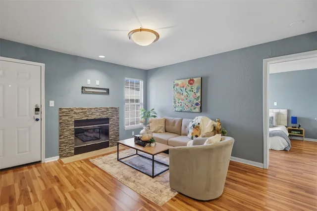 a living room with furniture and a fireplace