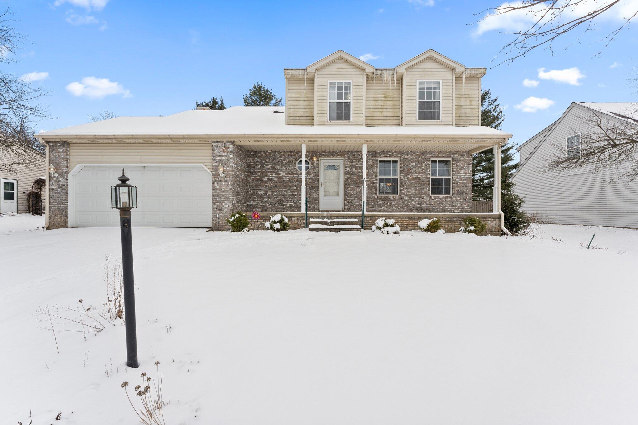 a view of house with yard