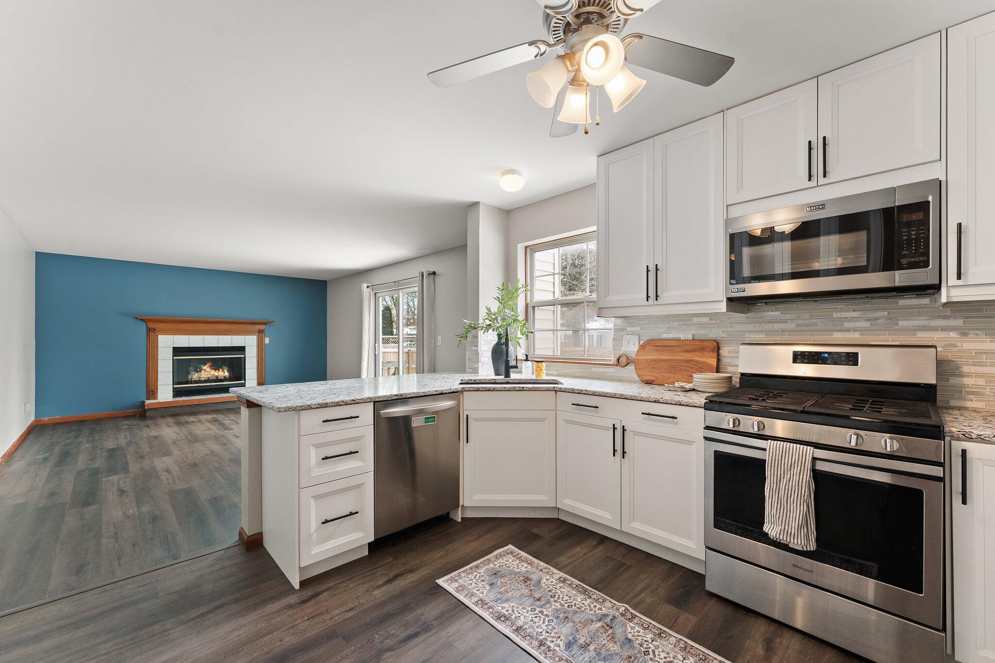 505 Wesley Road Kouts, IN 46347 - Photo 12 of 36 a kitchen with stainless steel appliances granite countertop a stove cabinets and microwave