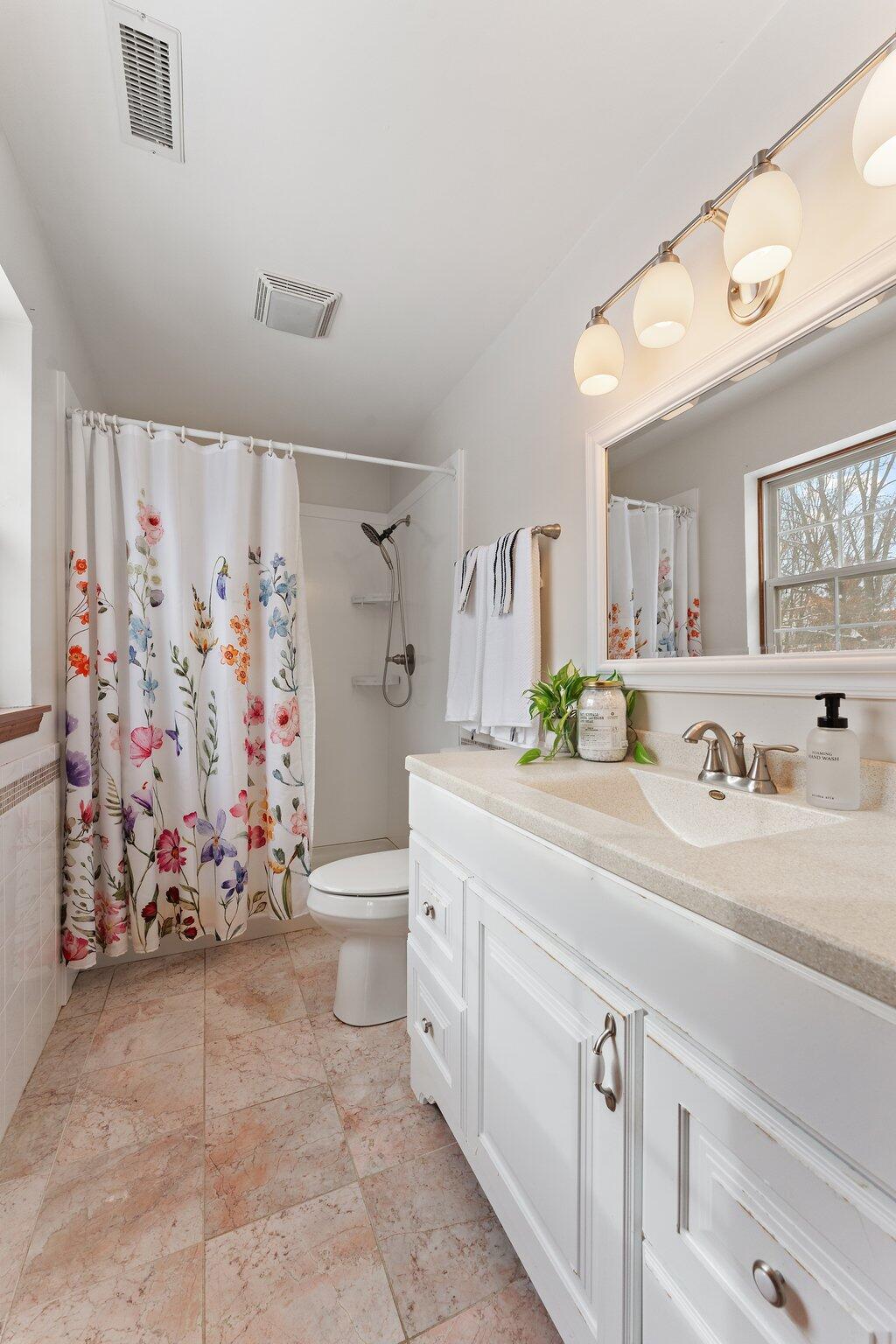 505 Wesley Road Kouts, IN 46347 - Photo 23 of 36 a bathroom with a double vanity sink mirror and toilet