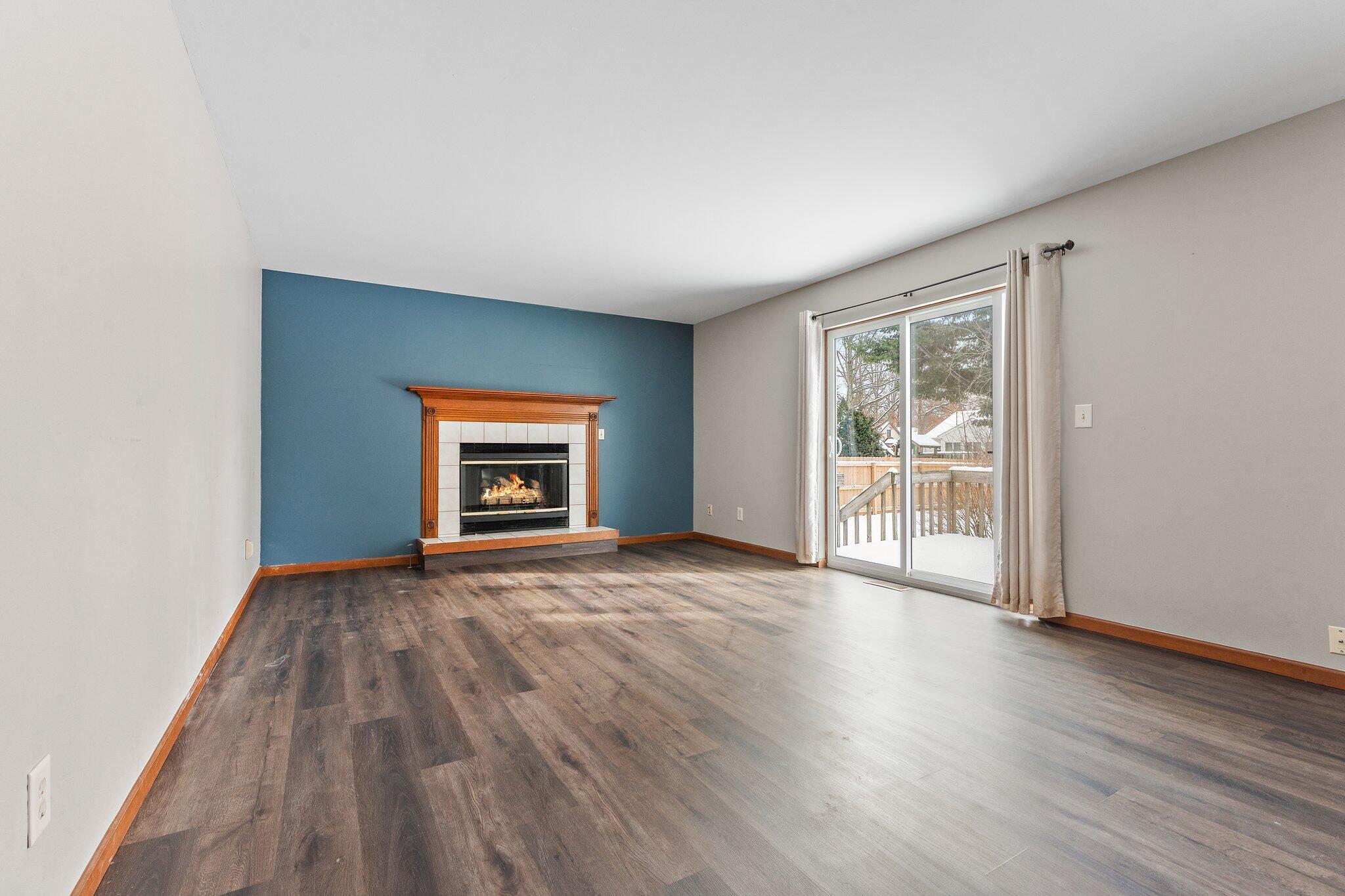 505 Wesley Road Kouts, IN 46347 - Photo 8 of 36 an empty room with wooden floor and a window