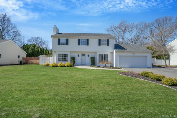 a front view of house with yard and green space