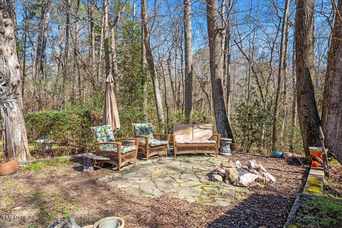 348 Raymond Tharrington Road Louisburg, NC 27549 - Photo 34 of 47 a backyard of a house with outdoor seating