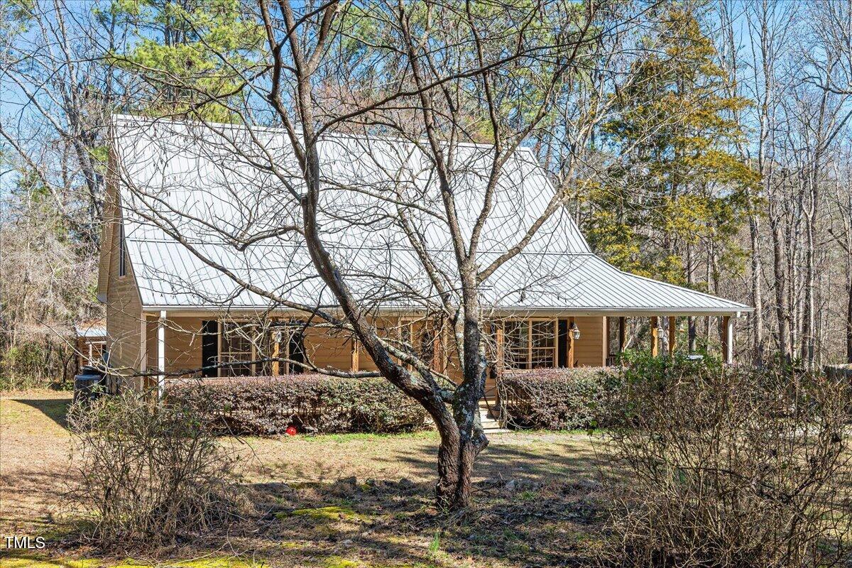 348 Raymond Tharrington Road Louisburg, NC 27549 - Photo 41 of 47 a front view of a house with a yard