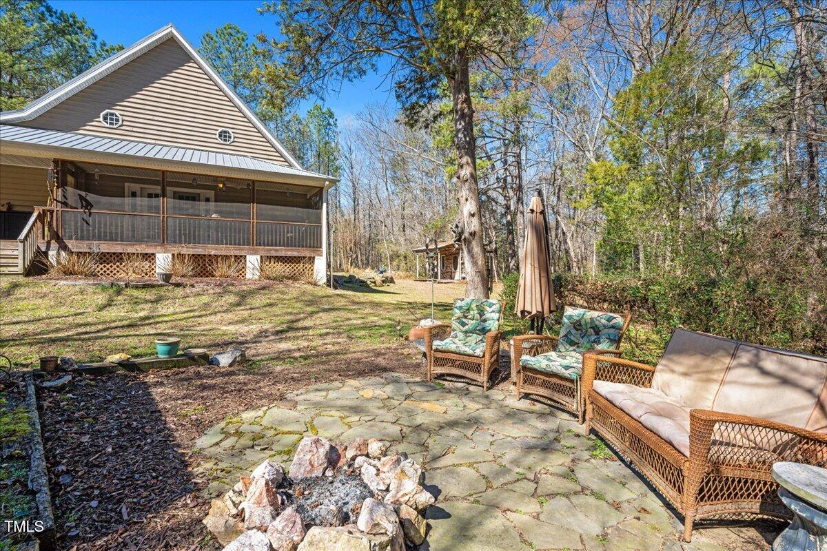 348 Raymond Tharrington Road Louisburg, NC 27549 - Photo 4 of 47 a view of a house with backyard and sitting area