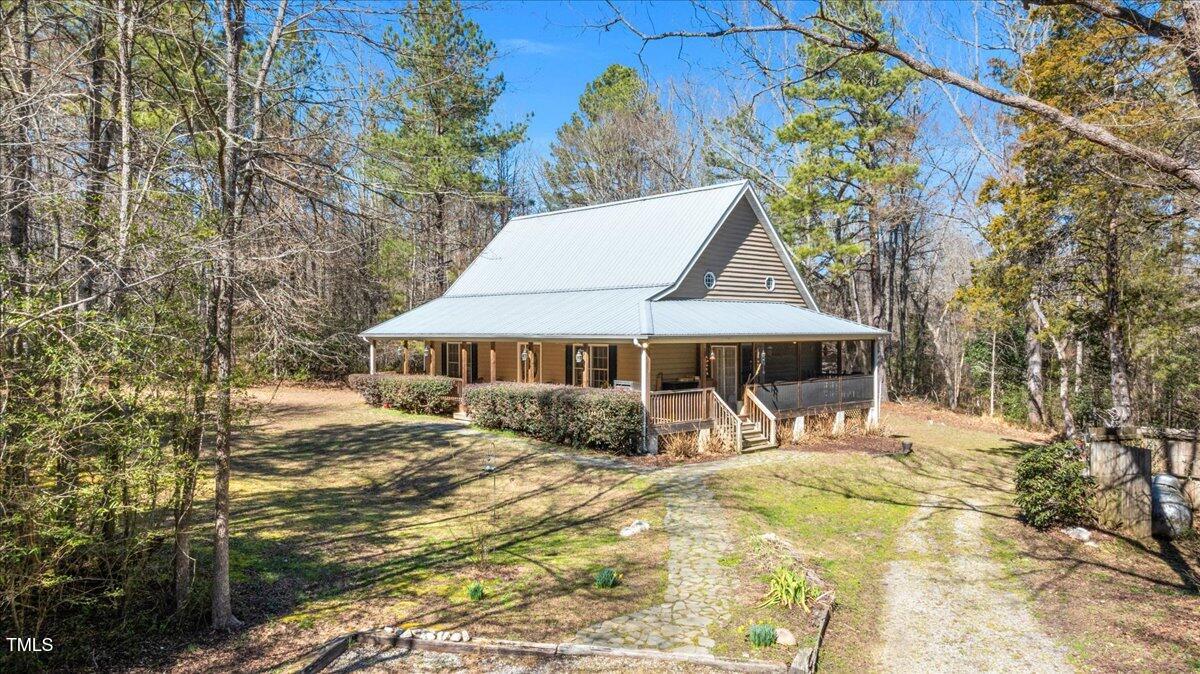 348 Raymond Tharrington Road Louisburg, NC 27549 - Photo 5 of 47 a view of patio with a table and chairs under an umbrella