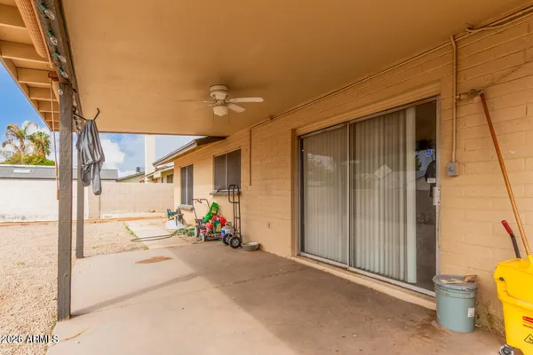a view of a patio with table and chairs