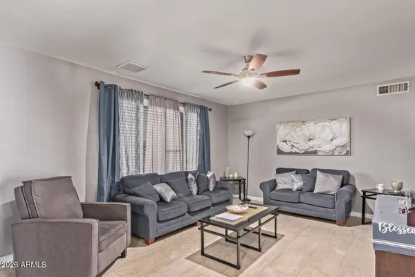 a living room with furniture and a large window