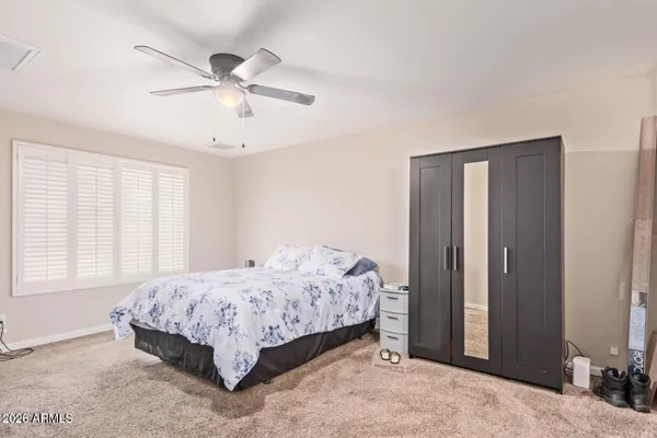 a bedroom with a bed and window