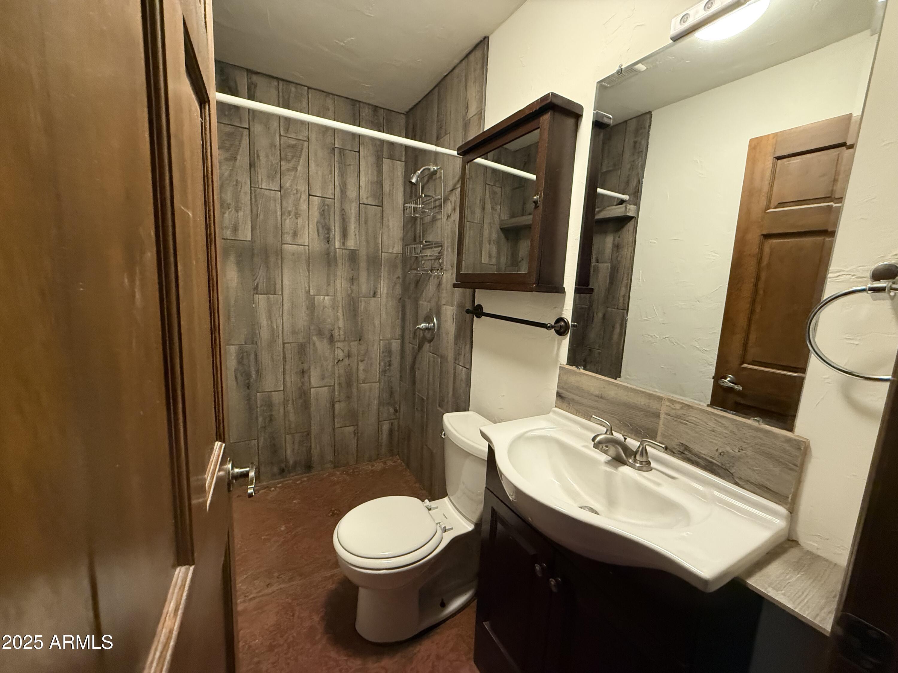 1730 East Lehi Road, Unit 2 Mesa, AZ 85203 - Photo 12 of 13 a bathroom with a sink toilet and shower