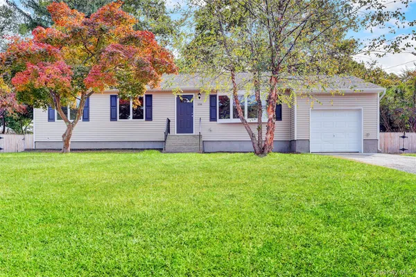 a front view of house with yard and green space