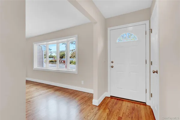 a view of an entryway with wooden floor
