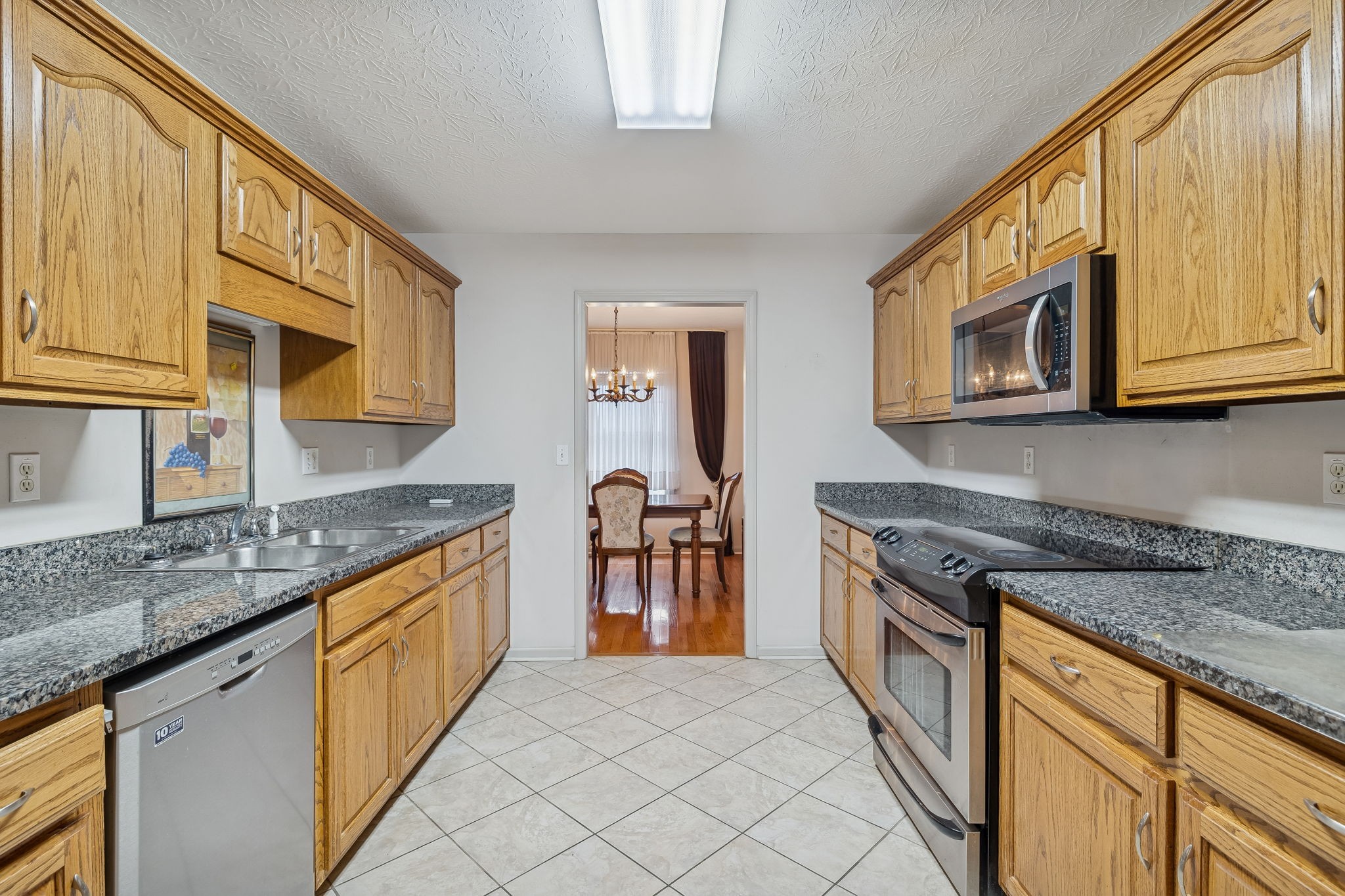 788 Long Creek Road Lafayette, TN 37083 - Photo 11 of 32 a kitchen with stainless steel appliances granite countertop a stove a sink and a microwave