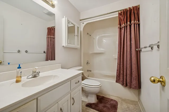 a view of a yard with plants and trees