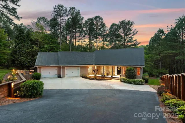 an aerial view of a house with a yard and garden