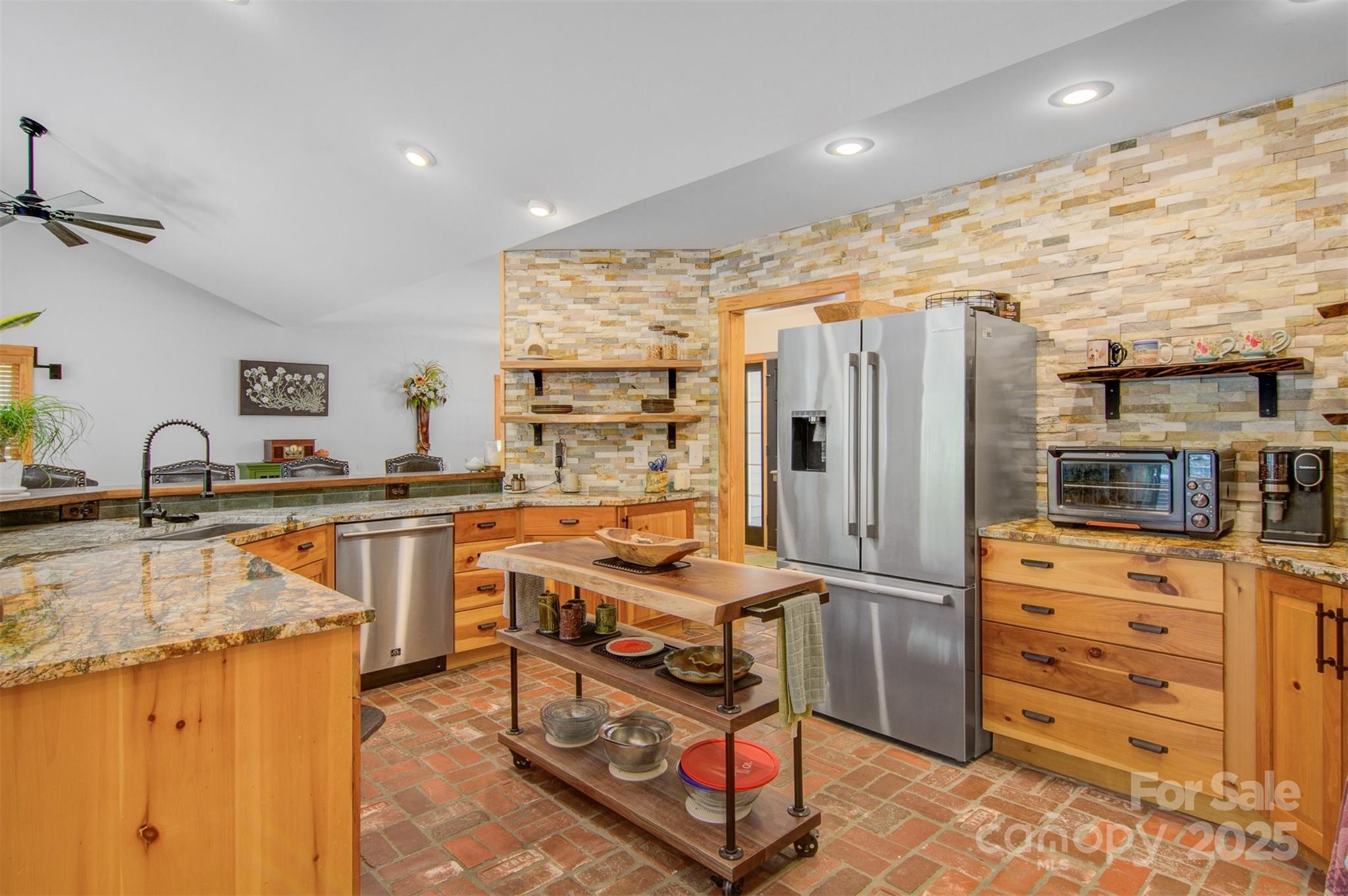 5690 Anchor Drive Granite Falls, NC 28630 - Photo 12 of 48 a kitchen with stainless steel appliances granite countertop a stove a sink and a refrigerator