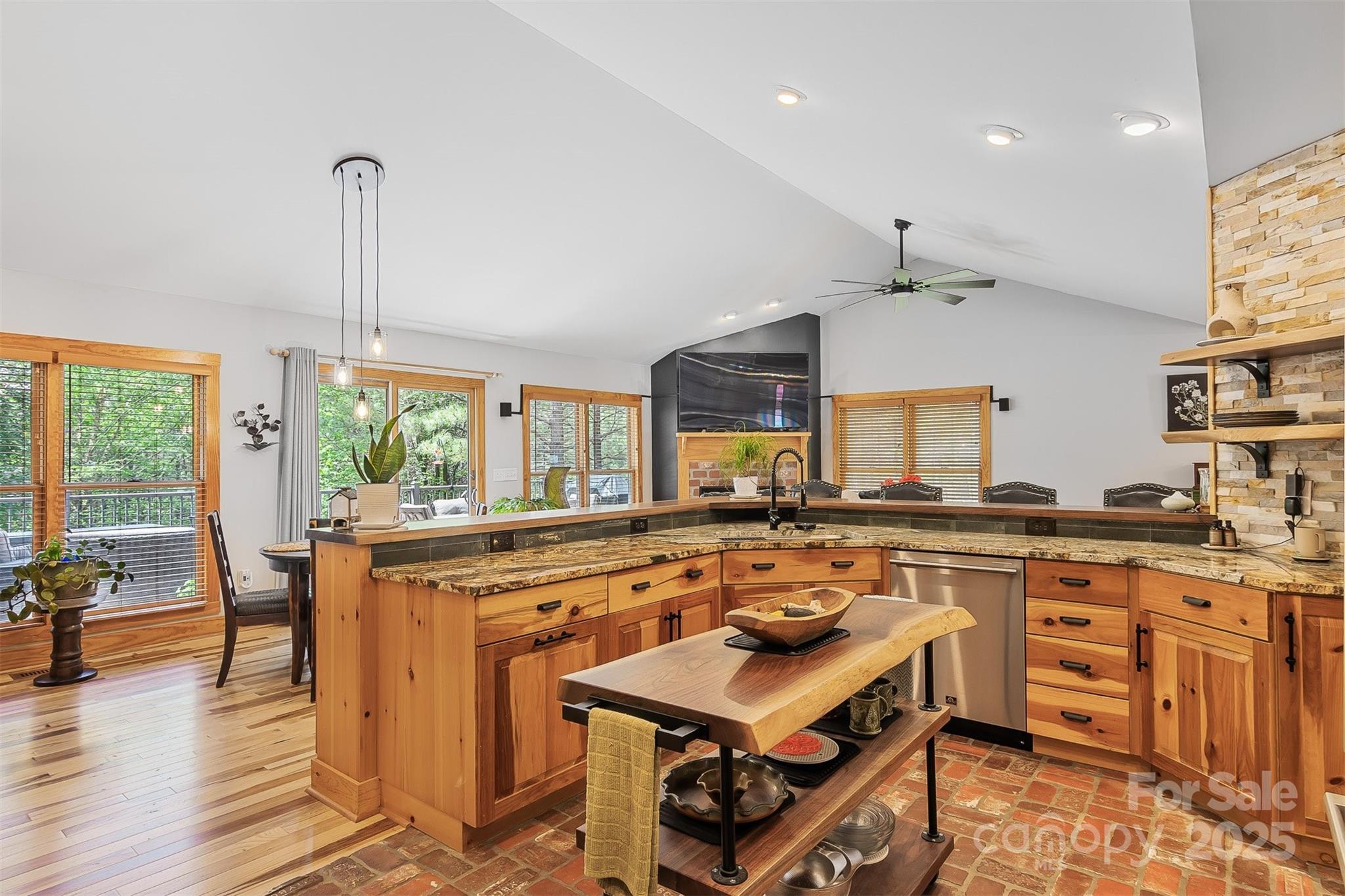 5690 Anchor Drive Granite Falls, NC 28630 - Photo 13 of 48 a kitchen with stainless steel appliances a stove a sink dishwasher with a dining table and chairs with wooden floor