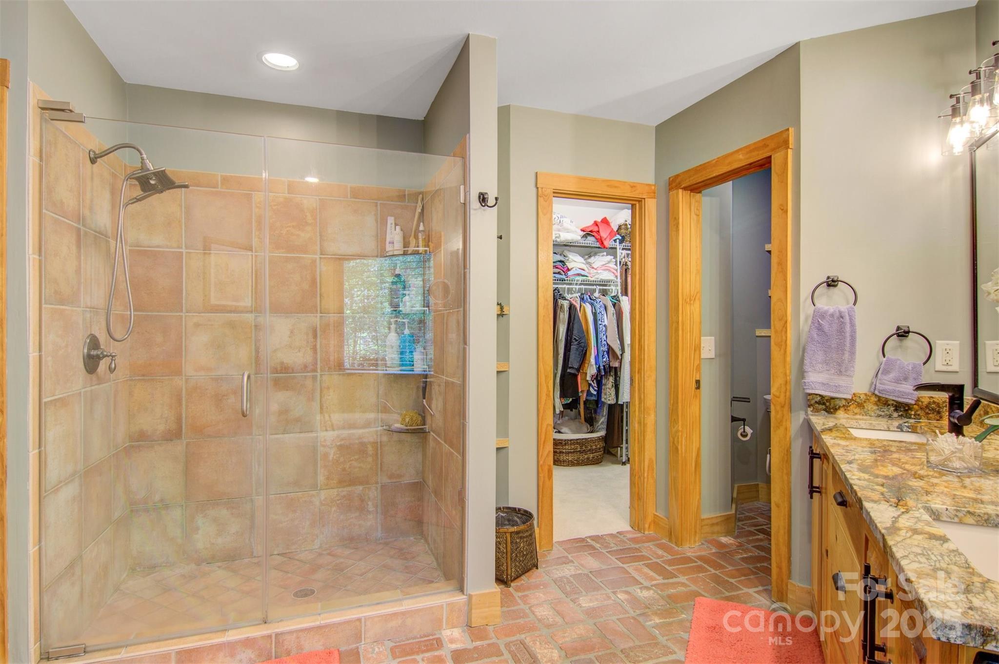 5690 Anchor Drive Granite Falls, NC 28630 - Photo 18 of 48 a bathroom with a granite countertop shower a sink and a mirror