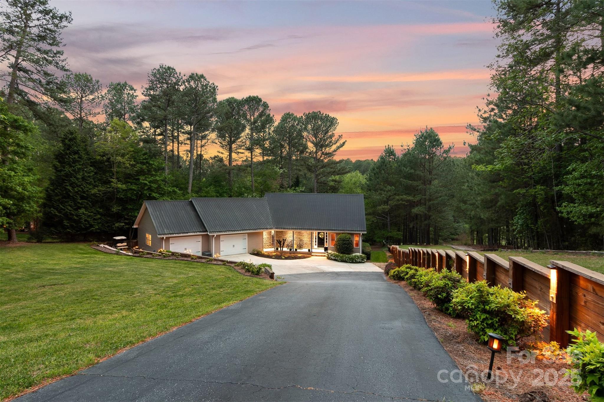 5690 Anchor Drive Granite Falls, NC 28630 - Photo 5 of 48 a view of a swimming pool with a garden and trees