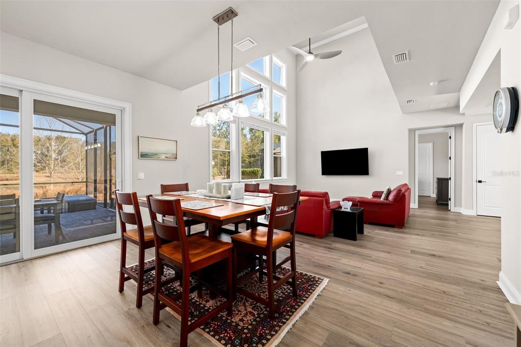10778 Southwest 34th Road Gainesville, FL 32608 - Photo 12 of 62 a view of a dining room with furniture wooden floor and chandelier