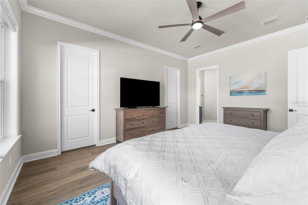 10778 Southwest 34th Road Gainesville, FL 32608 - Photo 19 of 62 a bedroom with a bed and a flat screen tv