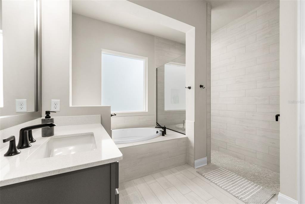 10778 Southwest 34th Road Gainesville, FL 32608 - Photo 20 of 62 a bathroom with a bathtub and a sink