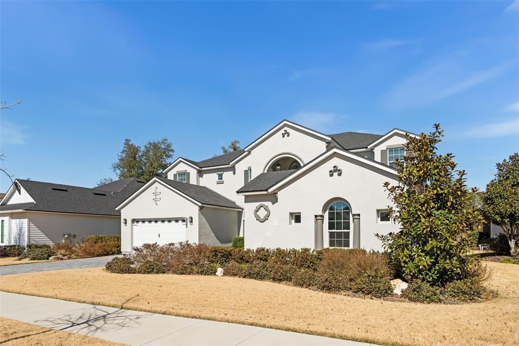 10778 Southwest 34th Road Gainesville, FL 32608 - Photo 2 of 62 a view of a white house with a yard