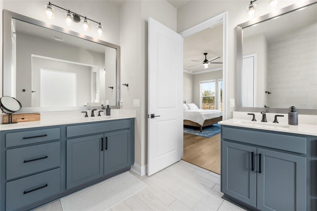 10778 Southwest 34th Road Gainesville, FL 32608 - Photo 23 of 62 a en suite bathroom with 2 sink and a mirror