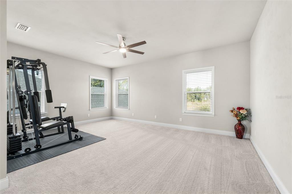 10778 Southwest 34th Road Gainesville, FL 32608 - Photo 24 of 55 a view of a room with gym equipment and windows