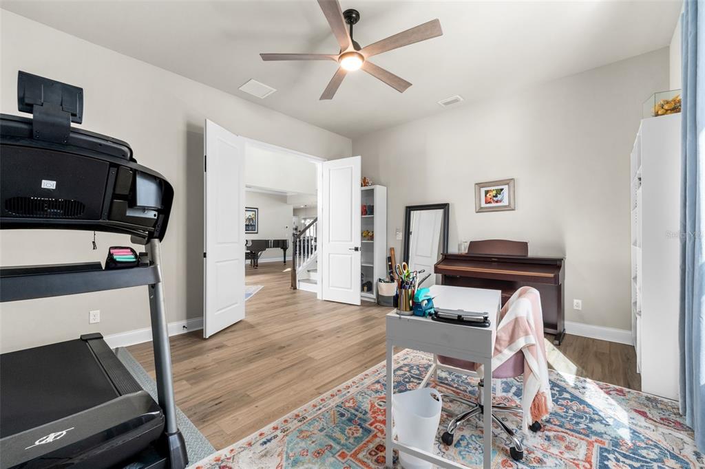 10778 Southwest 34th Road Gainesville, FL 32608 - Photo 25 of 62 a living room with furniture and a flat screen tv