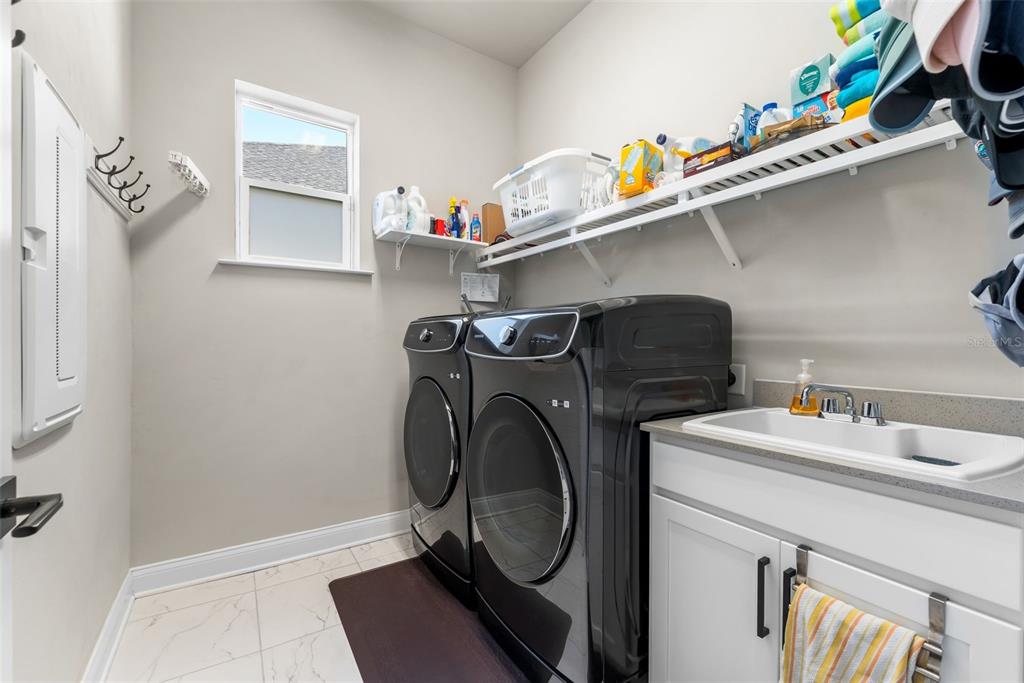 10778 Southwest 34th Road Gainesville, FL 32608 - Photo 27 of 62 a utility room with sink dryer and washer