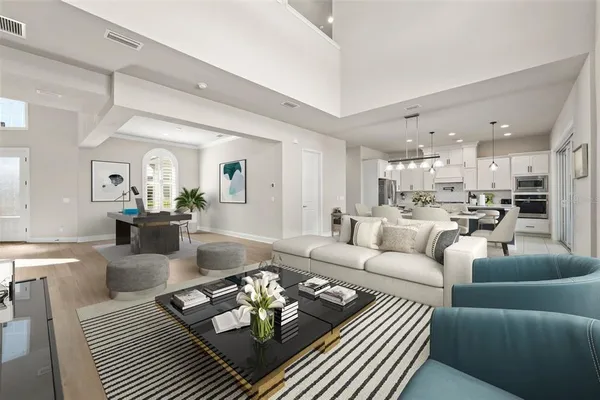 a living room with furniture hard wood floor and a table