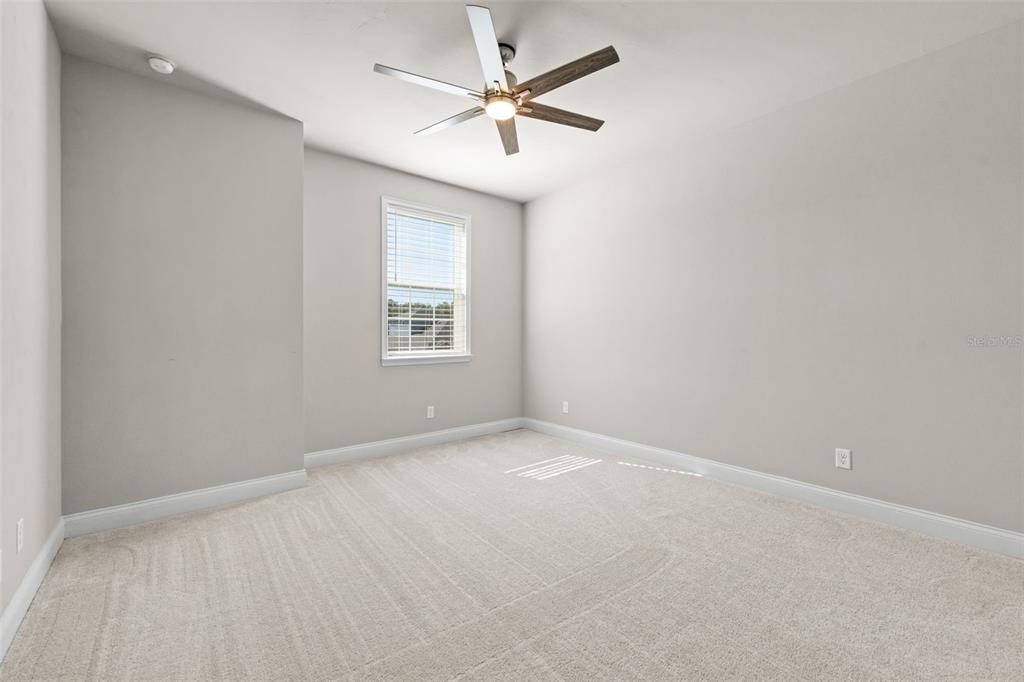 10778 Southwest 34th Road Gainesville, FL 32608 - Photo 33 of 62 an empty room with a window and a fan