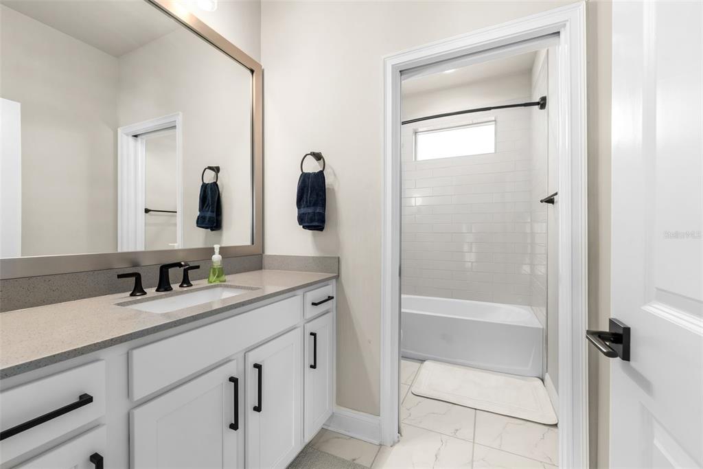 10778 Southwest 34th Road Gainesville, FL 32608 - Photo 34 of 62 a bathroom with a double vanity sink mirror and
