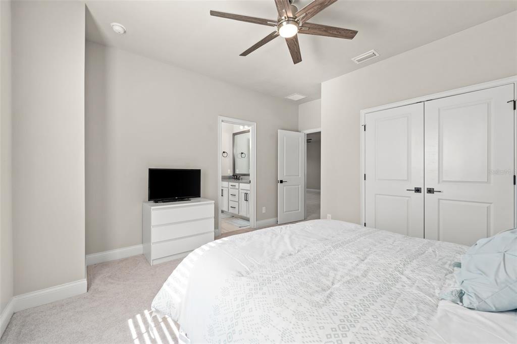 10778 Southwest 34th Road Gainesville, FL 32608 - Photo 36 of 62 a bedroom with a bed and a flat screen tv