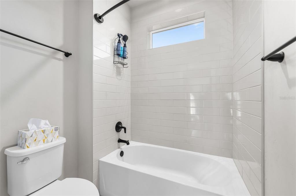 10778 Southwest 34th Road Gainesville, FL 32608 - Photo 37 of 62 a white bath tub sitting next to a white toilet