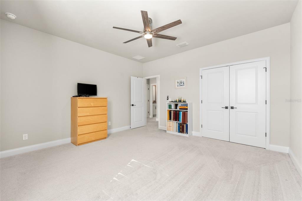 10778 Southwest 34th Road Gainesville, FL 32608 - Photo 39 of 62 an empty room with closet and ceiling fan