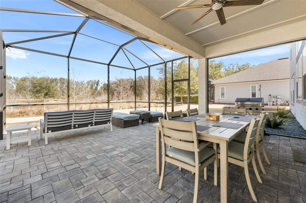 10778 Southwest 34th Road Gainesville, FL 32608 - Photo 42 of 62 a dining room with furniture and a floor to ceiling window