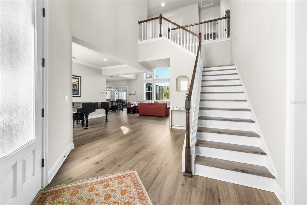 10778 Southwest 34th Road Gainesville, FL 32608 - Photo 6 of 62 a view of entryway and hall with wooden floor