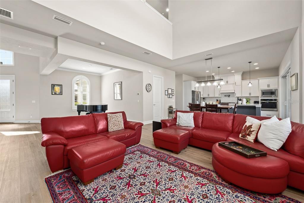 10778 Southwest 34th Road Gainesville, FL 32608 - Photo 10 of 62 a living room with furniture red walls and a rug