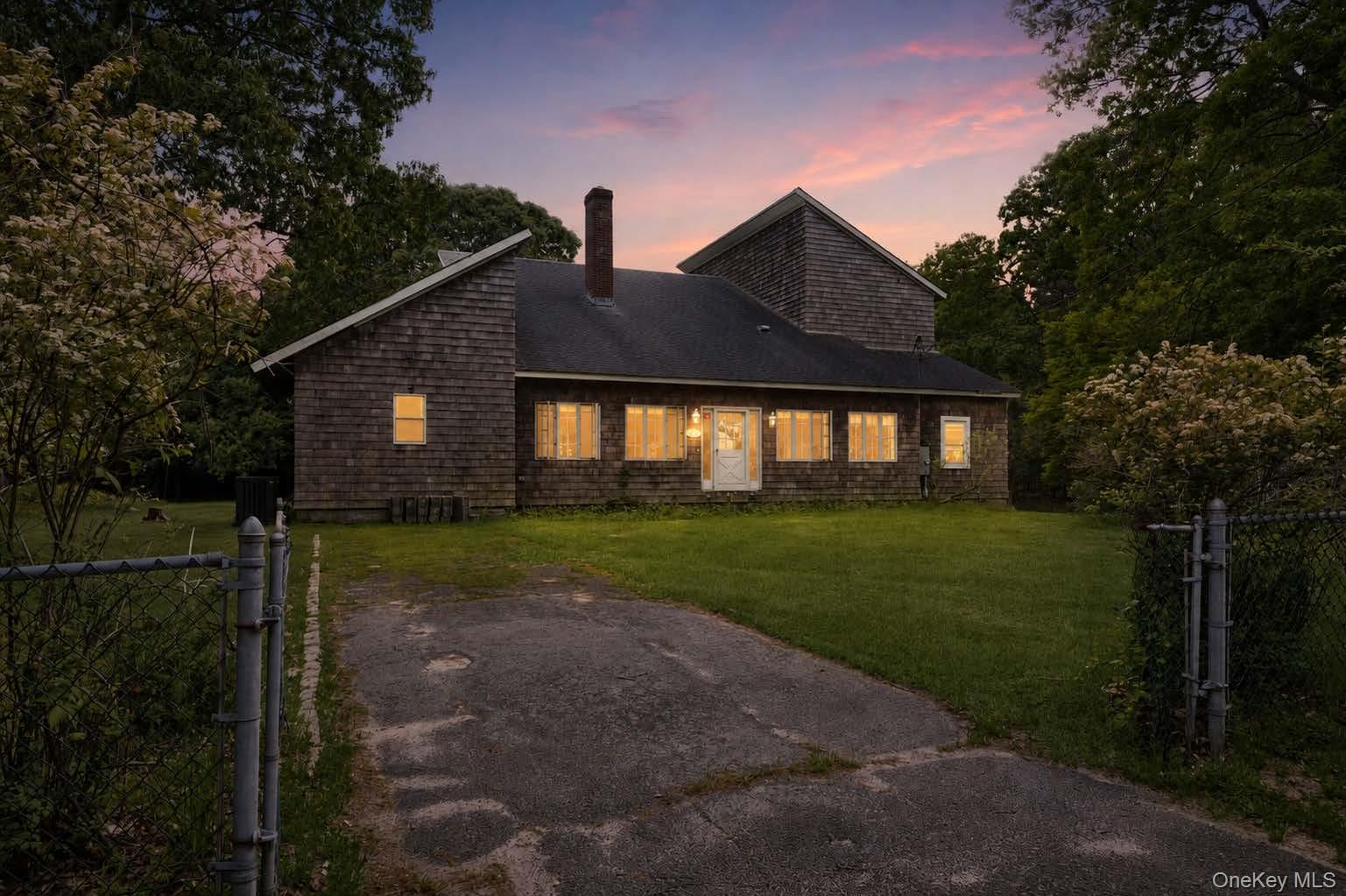 131 Red Creek Road Hampton Bays, NY 11946 - Photo 29 of 35 a front view of a house with garden